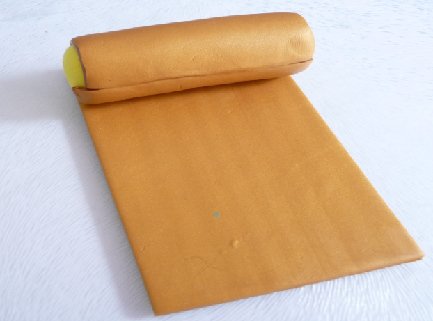 Yellow and gold clay cylinder on gold clay sheet