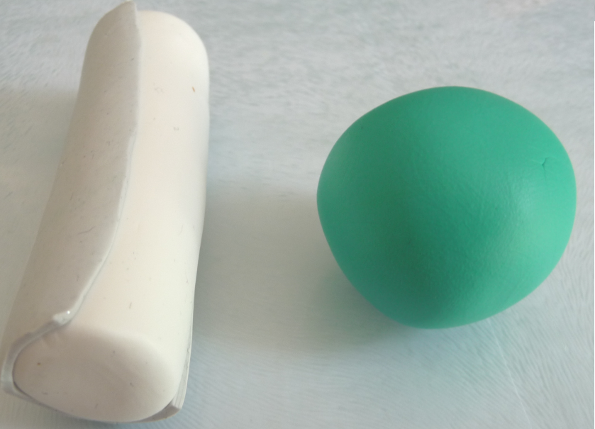 White and grey clay cylinder with round green cley ball